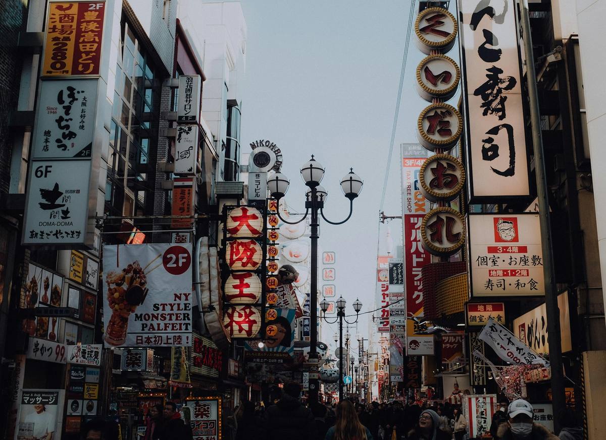 Handlegate der husveggene er dekket av japanske skilt i kanji og kana i alle størrelser og farger